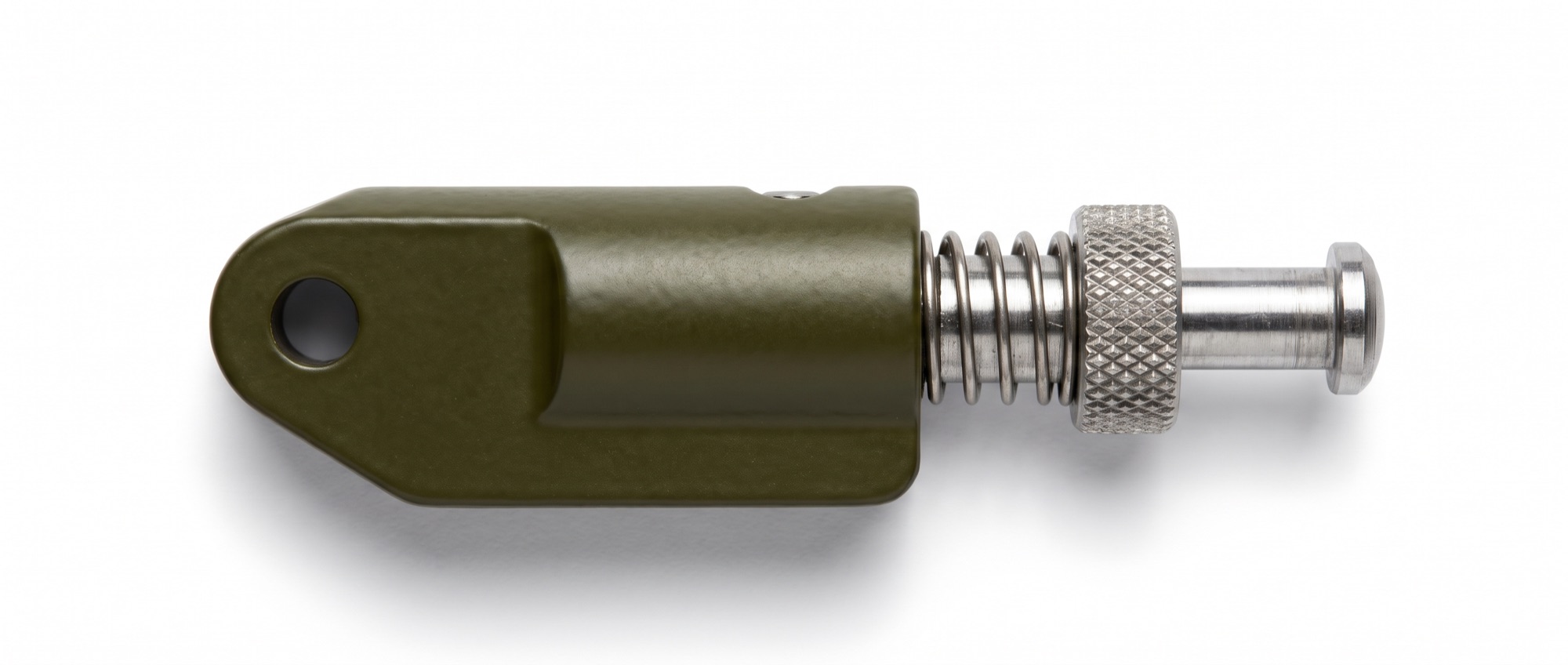 An olive-drab indexing plunger photographed from above: a spring-loaded steel pin that has to drop into place before the mechanism it holds can move.